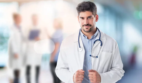 Portrait Male Doctor Standing Hospitals Corridor Unrecognizable Doctors Standing Background — стоковое фото