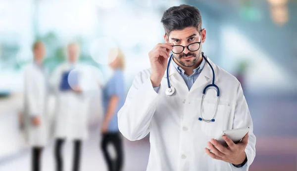 Portrait Male Doctor Holding His Patient Chart Digital Tablet While — 图库照片