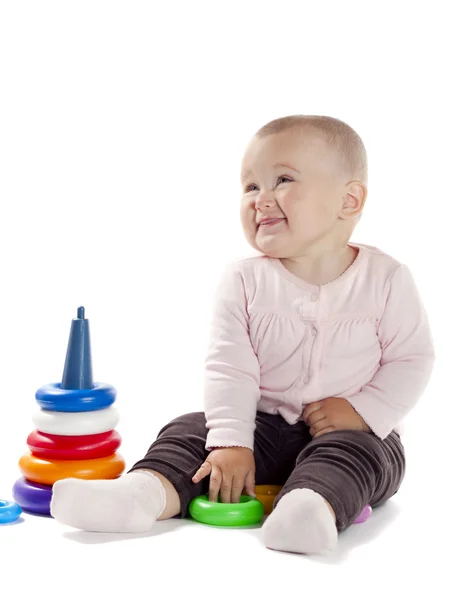 Little girl playing with pyramid — Stock Photo, Image