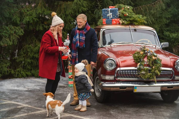 family near retro car with gifts