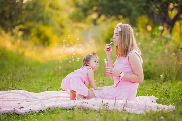 Madre e hija soplando burbujas —  Fotos de Stock