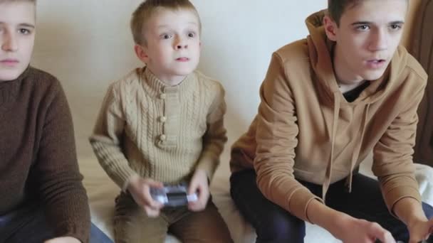 Children play on the console with joysticks in ruhs — Stock Video