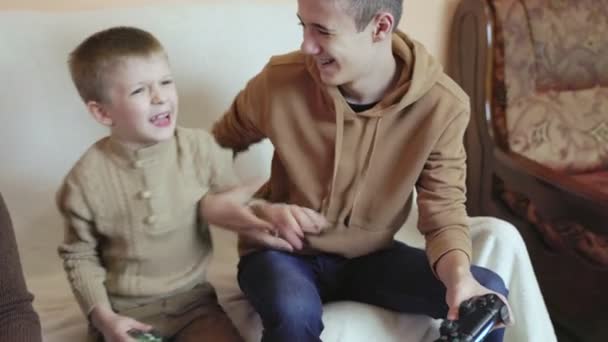 Children play on the console with joysticks in ruhs — Stock Video