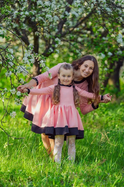 Mother and daughter walking in the garden — Stock Photo, Image