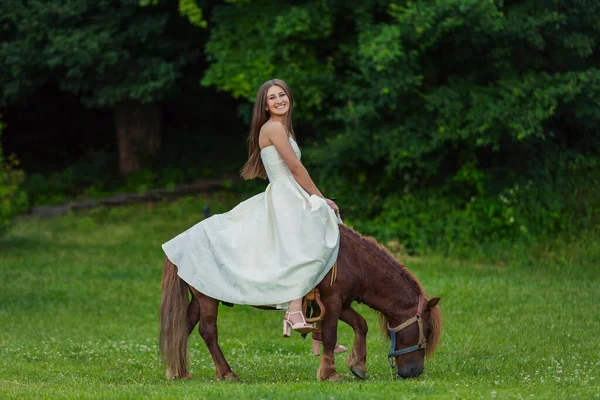 Meisje paardrijden een pony — Stockfoto