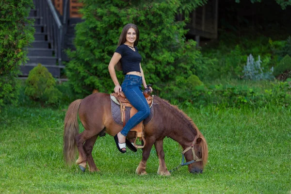 Girl riding a pony — Stock Photo, Image