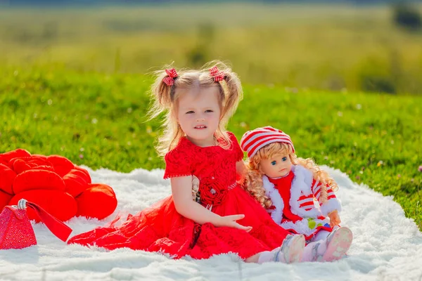 Girl playing with a doll — Stock Photo, Image