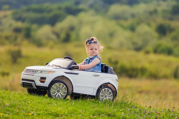 Child rides in his car — Stock Photo, Image