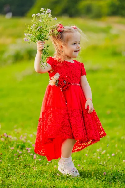 Girl in red dress and flowers — Stock Photo, Image
