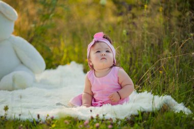 Çocuk battaniyeye oturuyor.