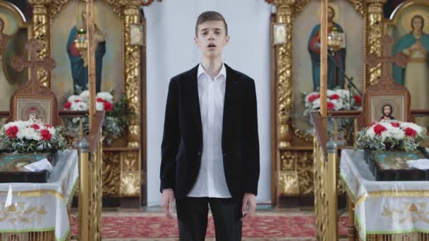 Kolinkivtsi by, Ukraina - 27 april 2022. Klostret av den heliga lika-apostlarna prins Vladimir. Pojken sjunger nära Altaret. — Stockvideo