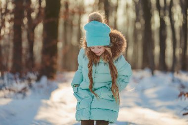Turkuaz ceketli ve şapkalı kız.