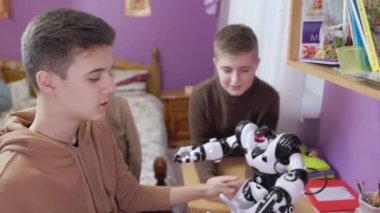 Children playing with toy robots