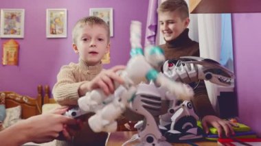 Children playing with toy robots