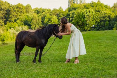 girl next to pony