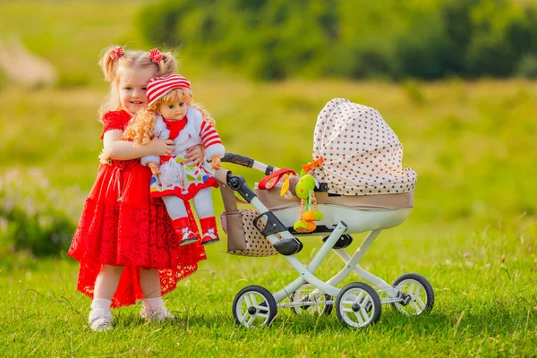 Girl rolls her doll —  Fotos de Stock