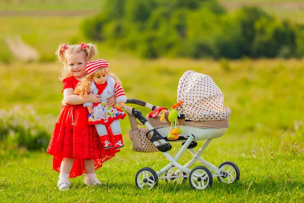 Girl rolls her doll —  Fotos de Stock