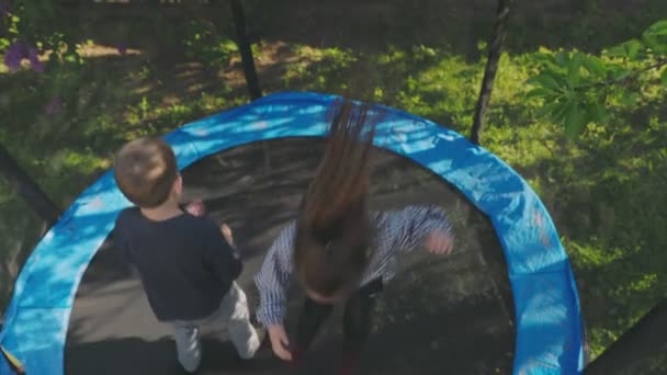 Two Children Have Fun Jumping Trampoline Top View — Stock Video