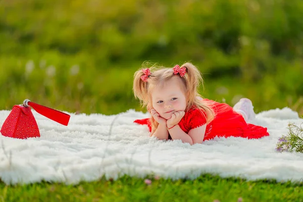 Little Girl Red Dress Lies White Blanket — Stock fotografie