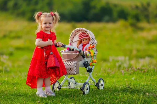 Girl Playing Doll Stroller Nature — стоковое фото