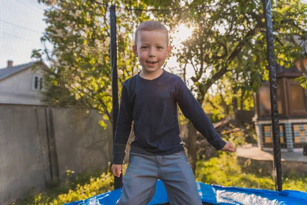 Little Boy Jumps Trampoline Stands Yard — Zdjęcie stockowe