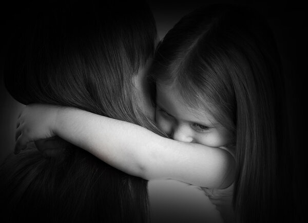 black and white portrait of a sad little girl and her mother