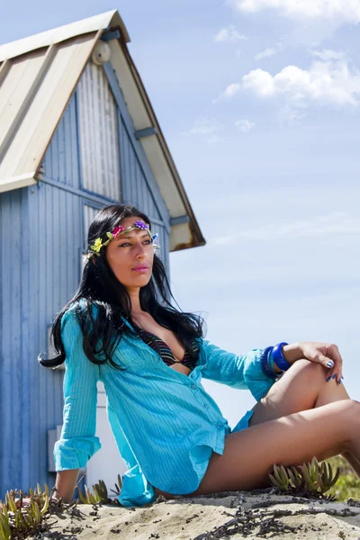 Красивая девушка на пляже рядом с домом из голубого дерева — стоковое фото