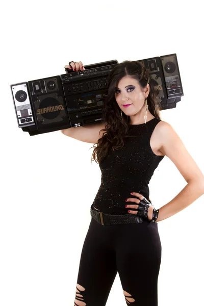 Beautiful girl in dark leather clothes holding a large retro radio — Stock Photo, Image