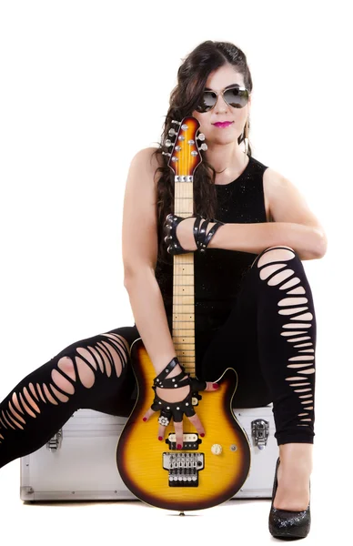 Beautiful girl in dark leather clothes holding an electric guitar — Stock Photo, Image