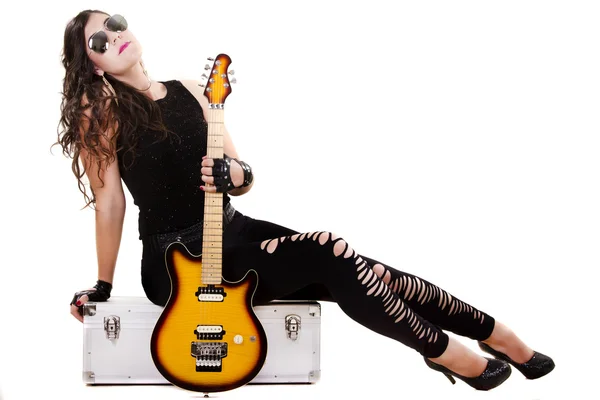 Beautiful girl in dark leather clothes holding an electric guitar — Stock Photo, Image