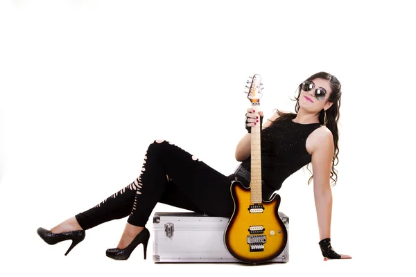 Beautiful girl in dark leather clothes holding an electric guitar — Stock Photo, Image