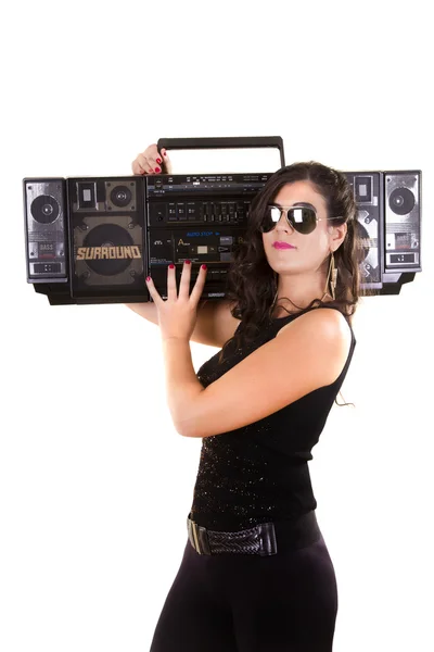 Beautiful girl in dark leather clothes holding a large retro radio — Stock Photo, Image