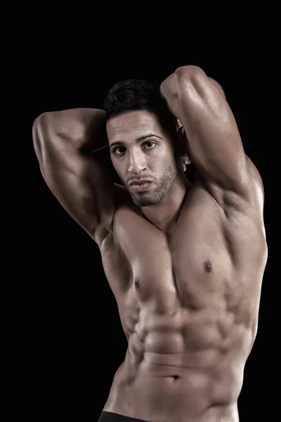 Muscled man on a black background — Stock Photo, Image