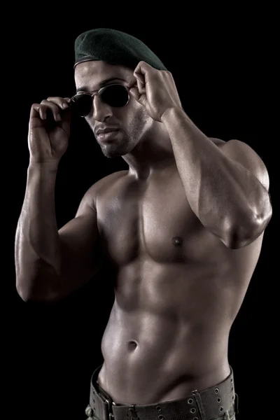 Muscled man on a black background — Stock Photo, Image