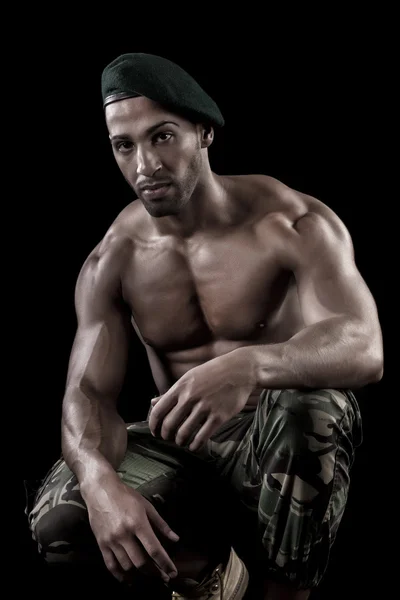 Muscled man on a black background — Stock Photo, Image