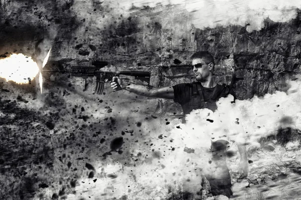 Menacing man firing a machine gun — Stock Photo, Image