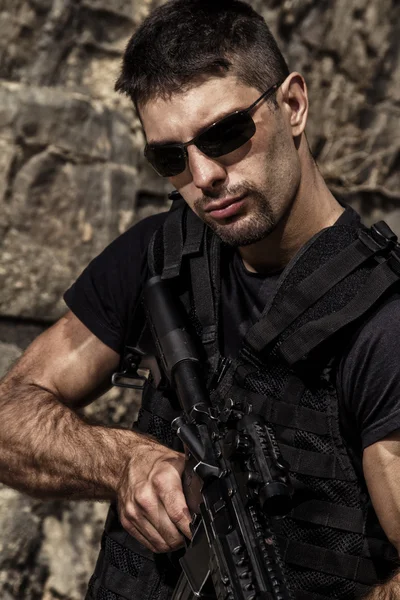 Menacing man with a machine gun Stock Picture