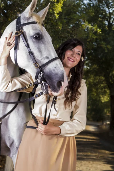 Classical girl with a white horse Royalty Free Stock Images