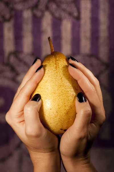 Holding a pear — Stock Photo, Image