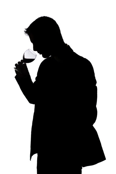 man smelling the aroma of fine red wine
