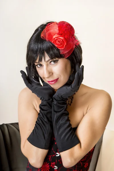 Mujer con un look vintage posando en un sofá . — Foto de Stock