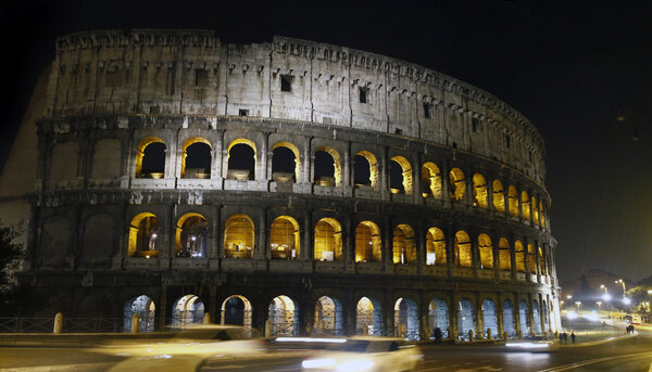 View of the beautiful Coliseum of Rome in Italy illuminated at night.
