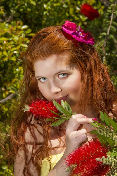 Young woman posing in a garden — Stock Photo, Image