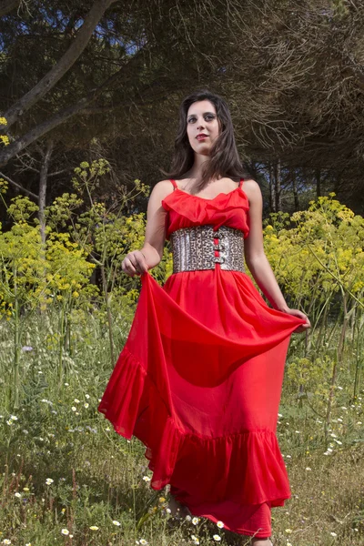 Young woman in a red dress — Stock Photo, Image