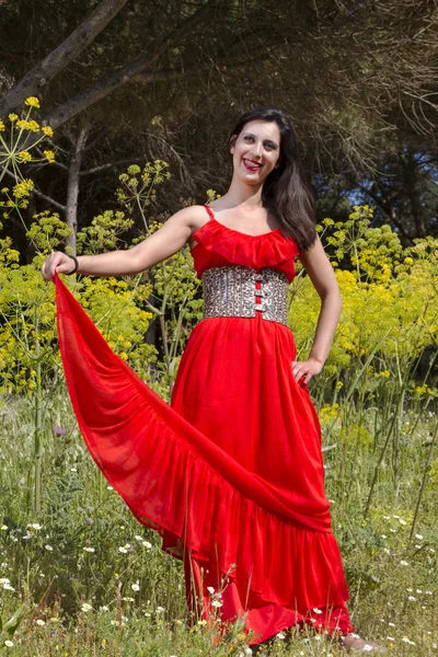 Young woman in a red dress — Stock Photo, Image