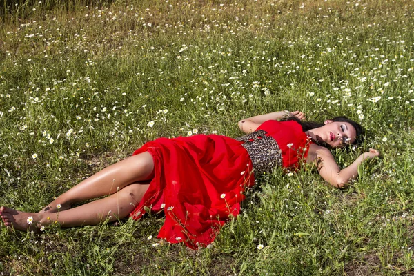 Young woman in a red dress — Stock Photo, Image