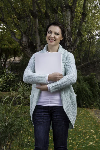 Young woman holding a blank canvas — Stock Photo, Image