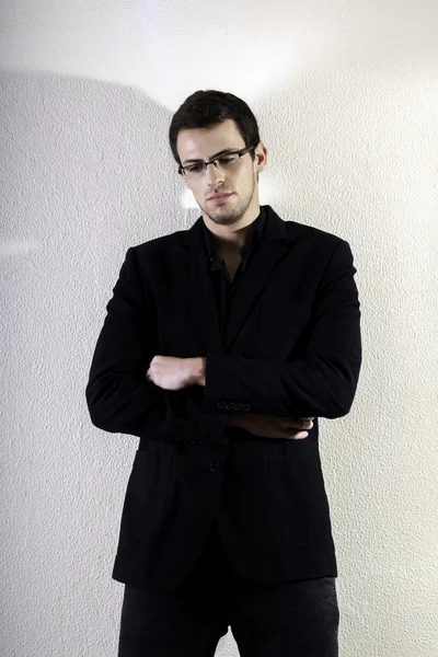 Young man against a white wall — Stock Photo, Image