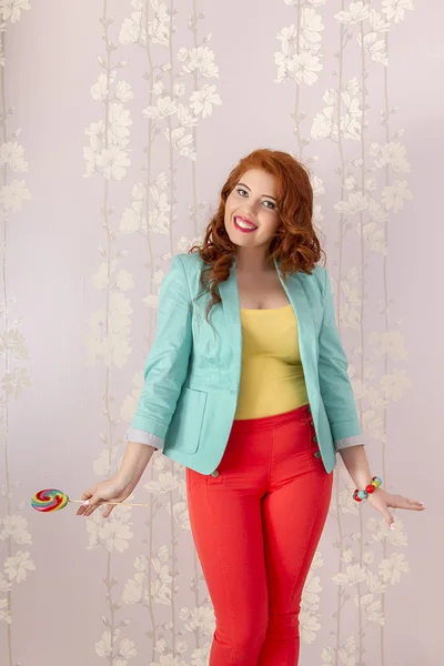 Beautiful redhead girl with a lollipop candy — Stock Photo, Image