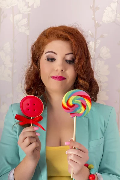 Beautiful redhead girl with a lollipop candy — Stock Photo, Image